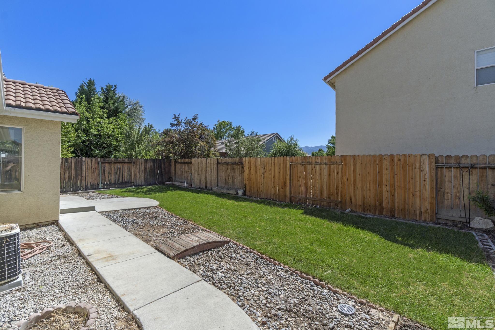 9721 Northmont Lane Reno, NV 89521 - Photo 32 of 40 a view of a backyard with wooden fence