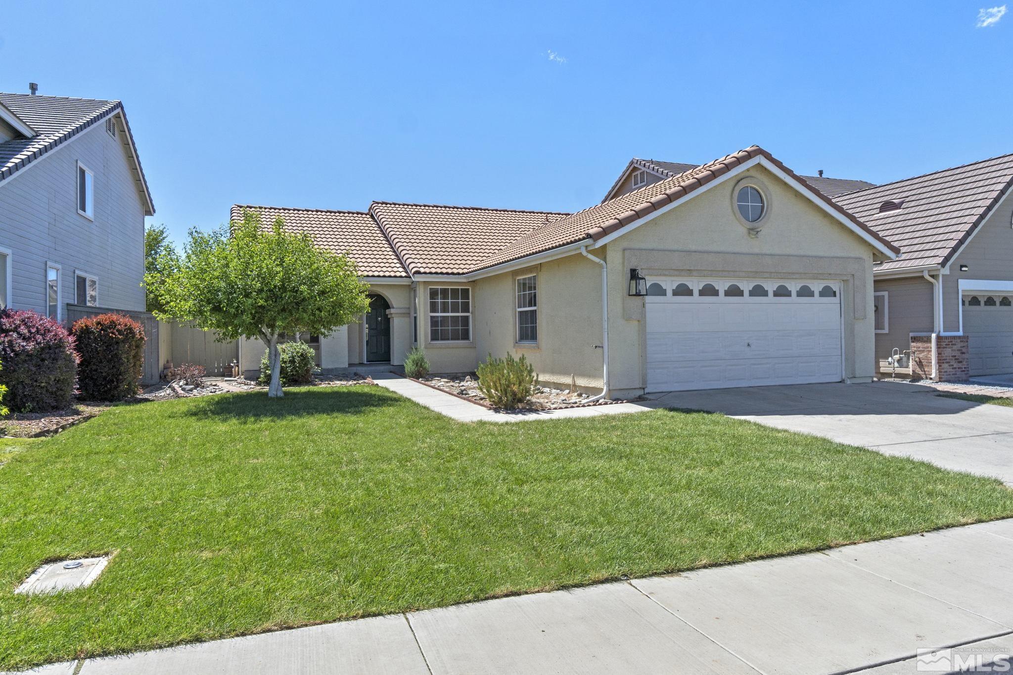 9721 Northmont Lane Reno, NV 89521 - Photo 34 of 40 a view of a house with a yard and a garden