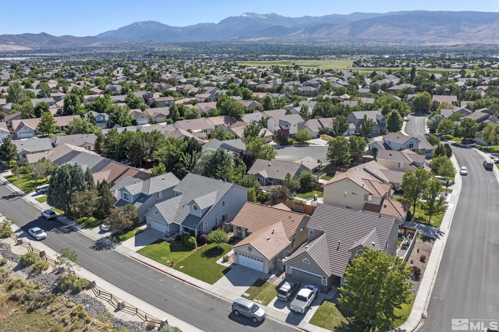9721 Northmont Lane Reno, NV 89521 - Photo 38 of 40 an aerial view of a city with lots of residential buildings and mountain view in back