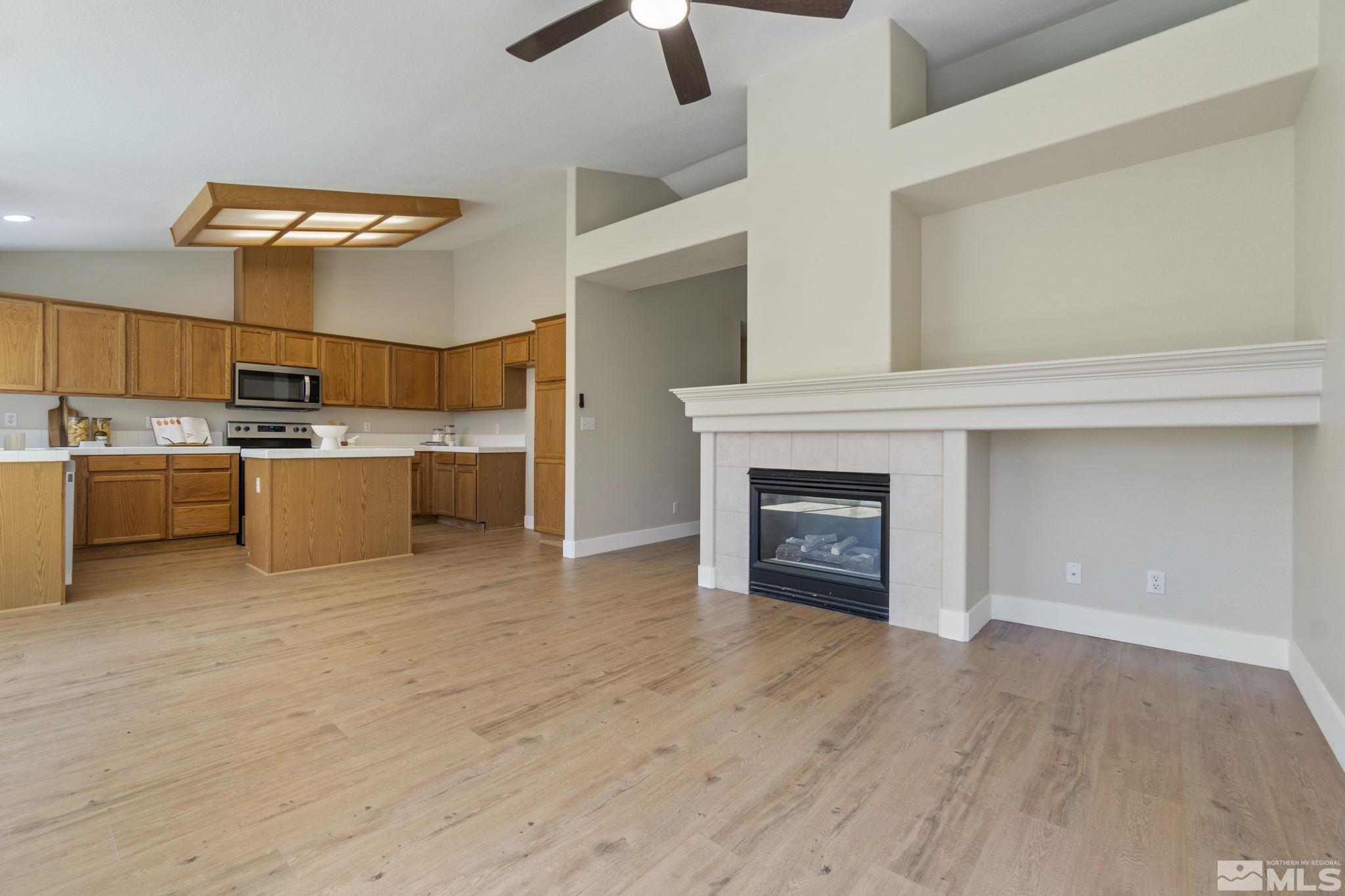 9721 Northmont Lane Reno, NV 89521 - Photo 4 of 40 a view of a kitchen with a sink and a fireplace
