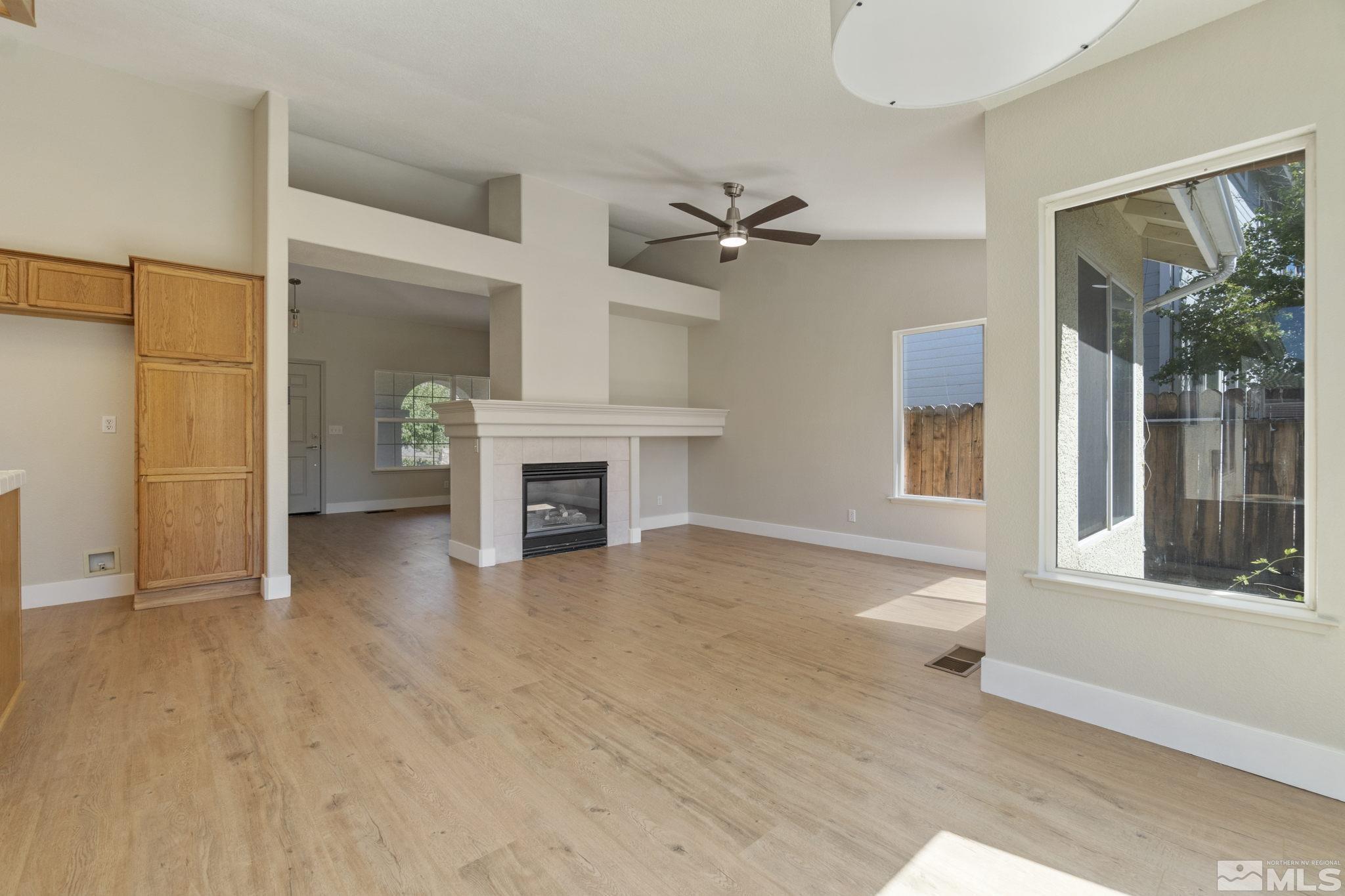 9721 Northmont Lane Reno, NV 89521 - Photo 10 of 40 a view of livingroom with furniture fire place and window