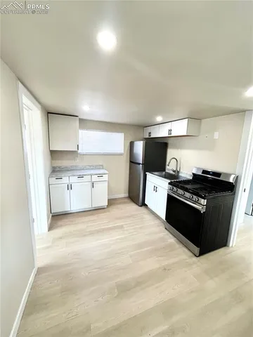a large kitchen with a stove top oven