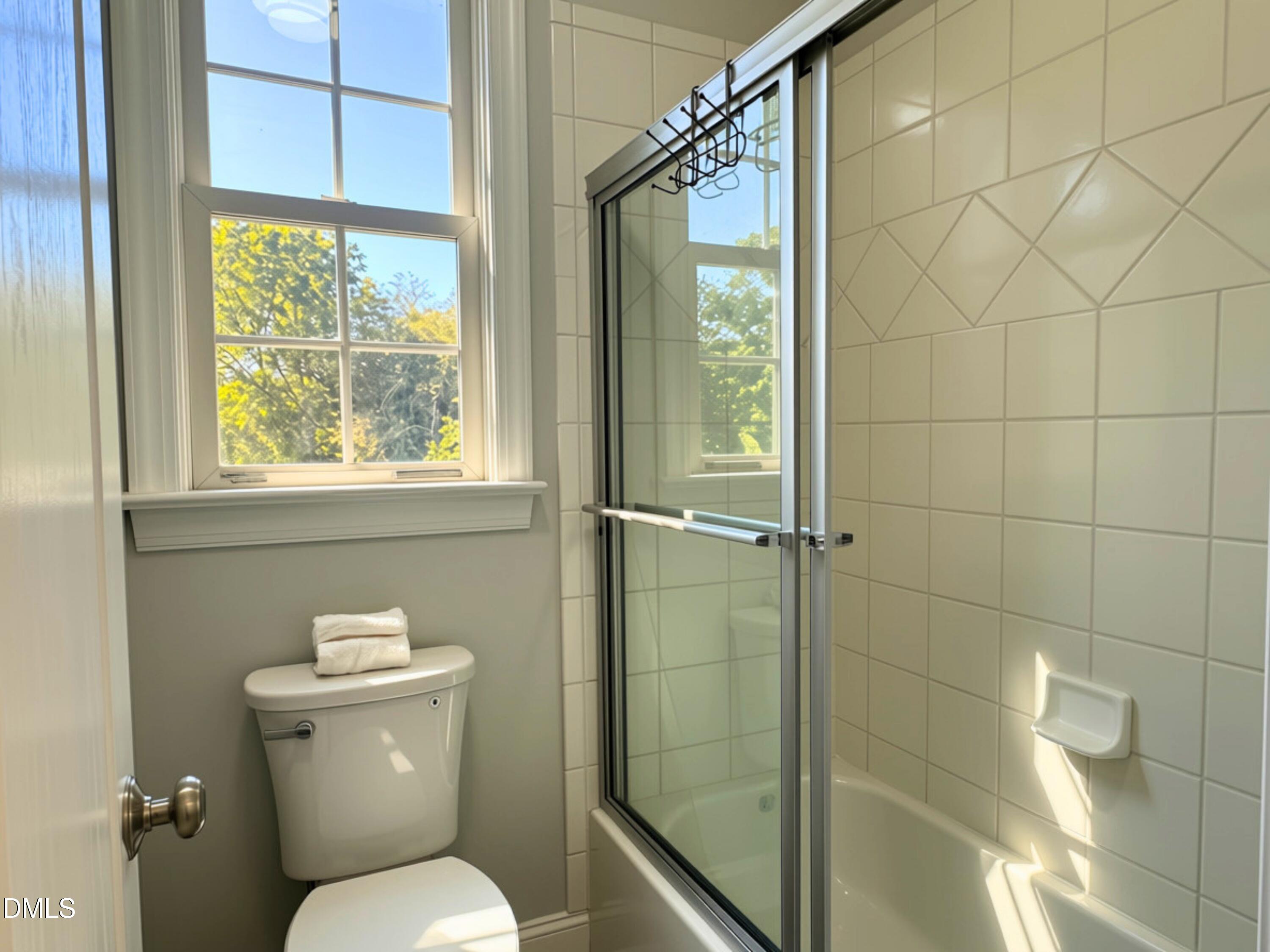 3100 Donlin Drive Wake Forest, NC 27587 - Photo 35 of 67 White subway tile shower surround with decorative accent band and glass enclosure