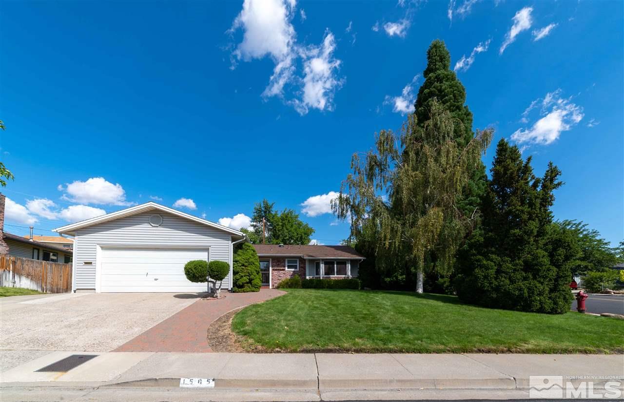 1585 Surf Way Reno, NV 89503 - Photo 1 of 16 a front view of a house with a yard and garage