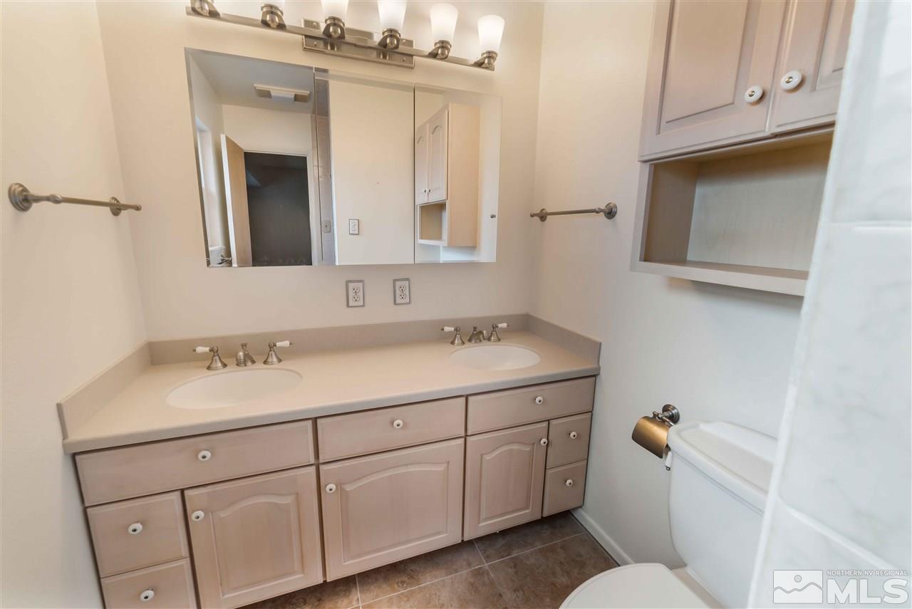 1585 Surf Way Reno, NV 89503 - Photo 11 of 16 a bathroom with a sink vanity and mirror