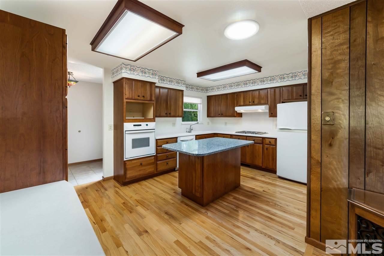1585 Surf Way Reno, NV 89503 - Photo 2 of 16 a kitchen with stainless steel appliances granite countertop a stove a sink and a refrigerator