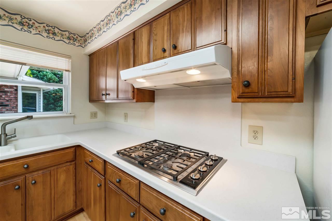 1585 Surf Way Reno, NV 89503 - Photo 4 of 16 a kitchen with wooden cabinets and a stove top oven