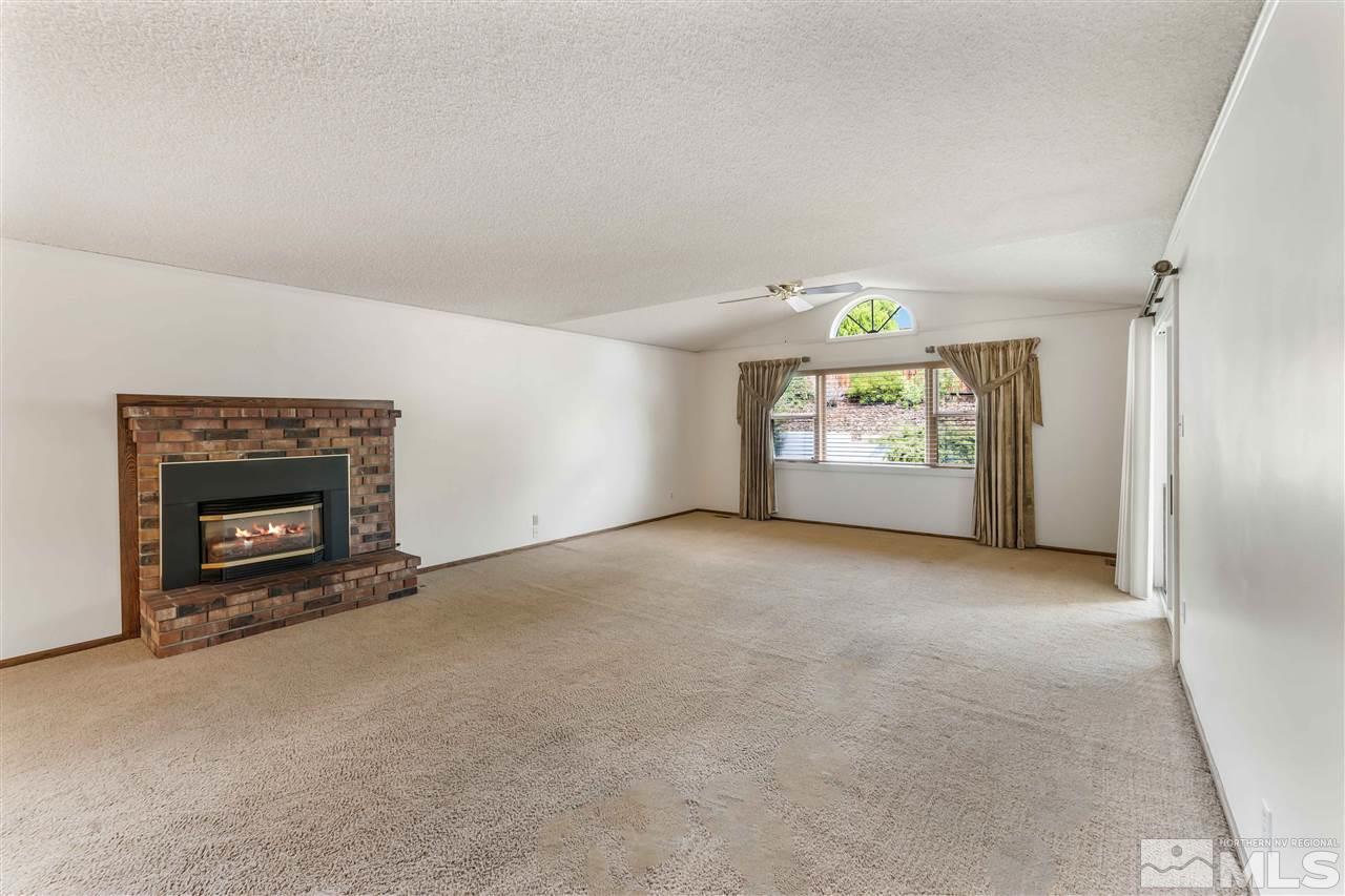 1585 Surf Way Reno, NV 89503 - Photo 6 of 16 an empty room with windows and fireplace