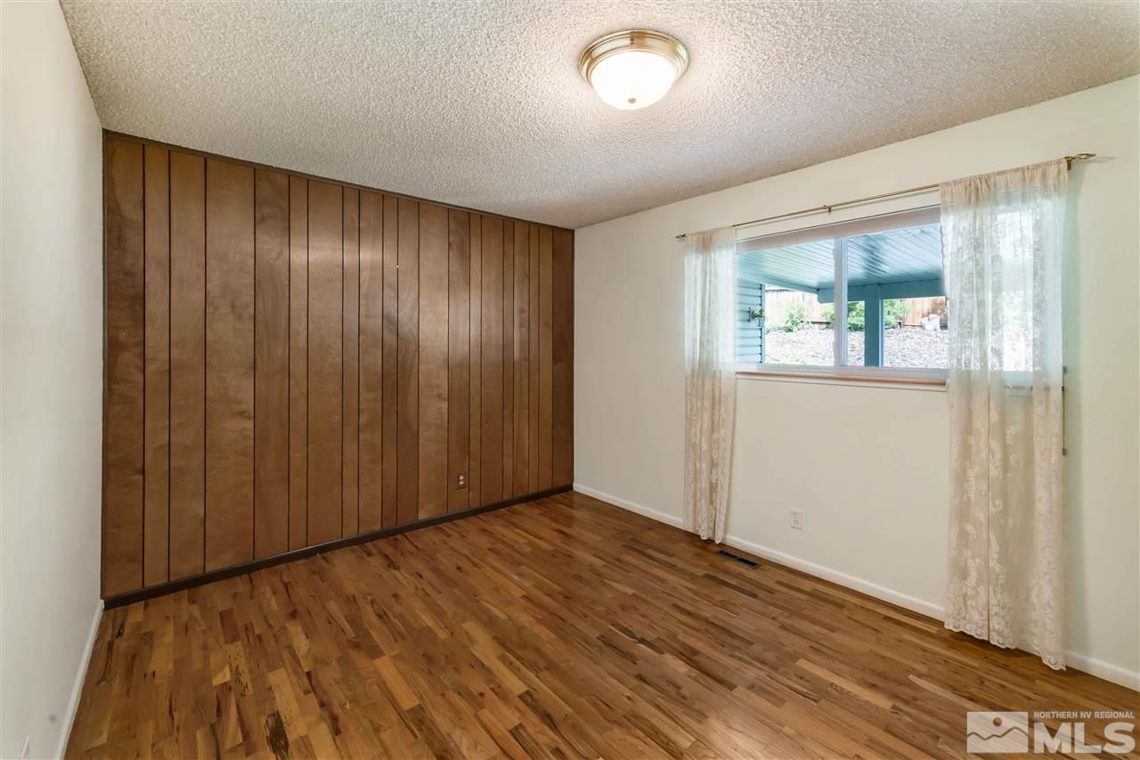 1585 Surf Way Reno, NV 89503 - Photo 7 of 16 an empty room with wooden floor and windows