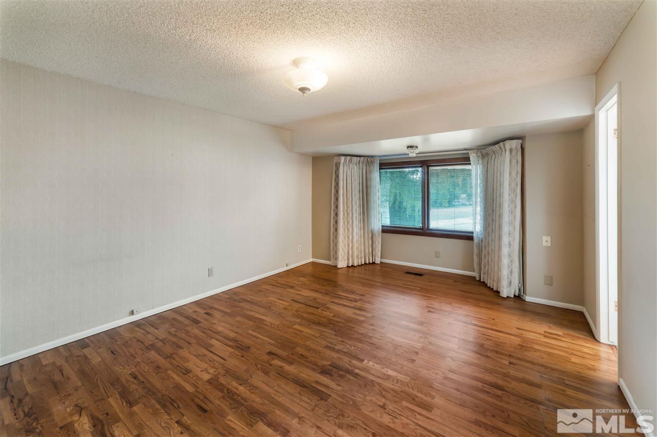 1585 Surf Way Reno, NV 89503 - Photo 10 of 16 an empty room with wooden floor and windows