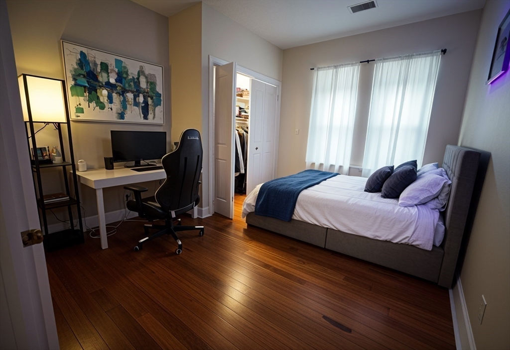 191 Boylston Street, Unit 1 Boston, MA 02130 - Photo 6 of 13 a bedroom with a bed and a desk