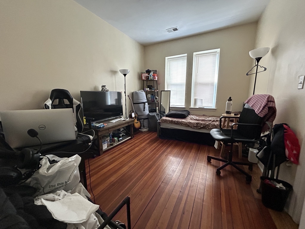 191 Boylston Street, Unit 1 Boston, MA 02130 - Photo 9 of 13 a living room with furniture and a wooden floor