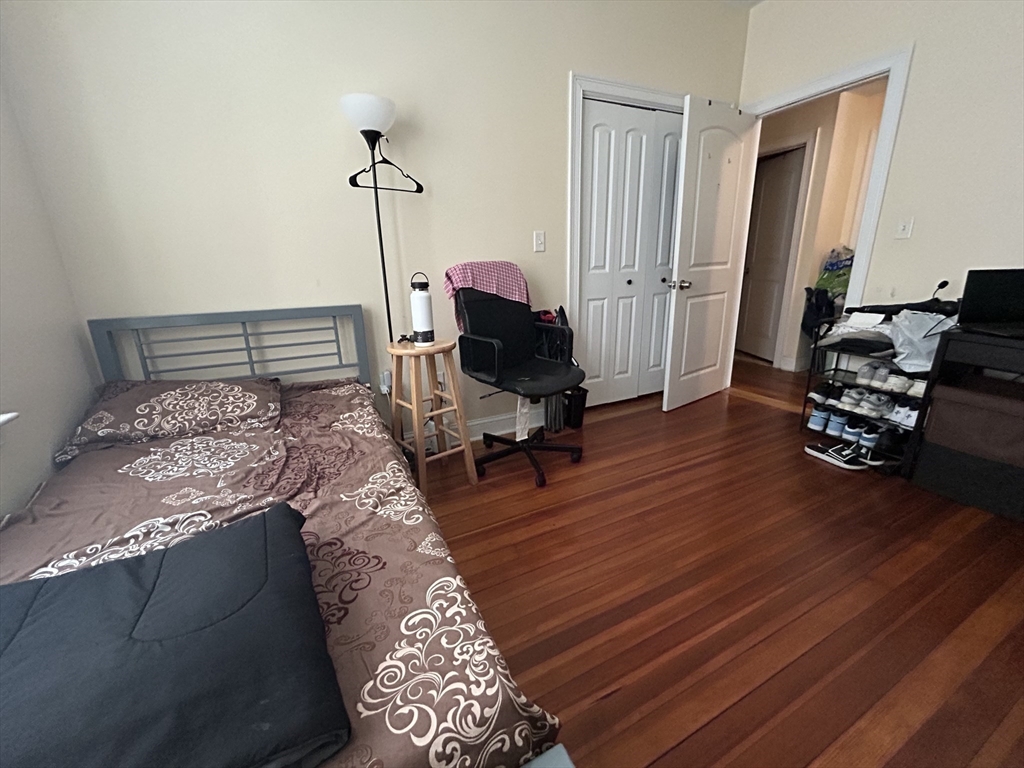 191 Boylston Street, Unit 1 Boston, MA 02130 - Photo 10 of 13 a bedroom with a bed and wooden floor