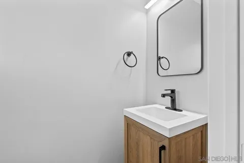 an empty room with a window and a ceiling fan