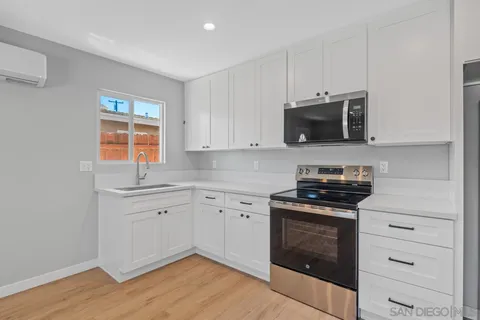 a bathroom with a toilet a sink a mirror a vanity and shower
