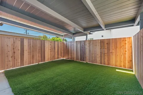 a view of a small space with wooden floor and a window