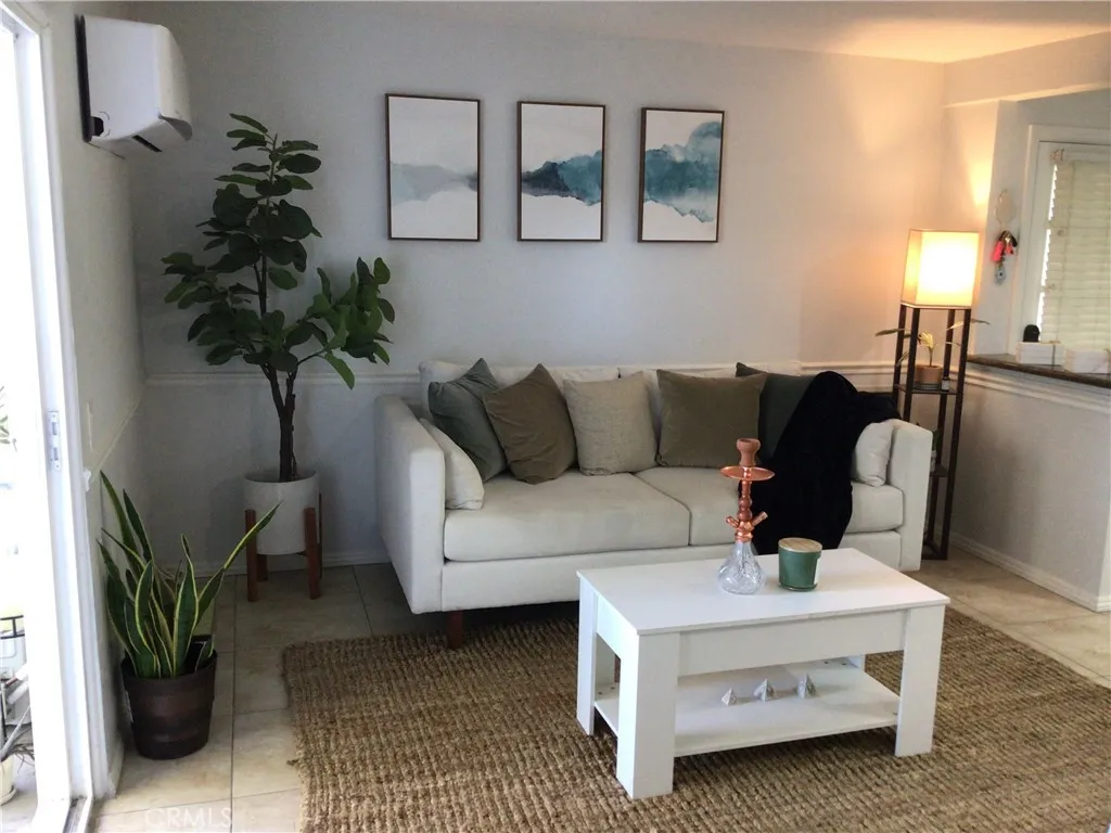 a living room with furniture and a potted plant