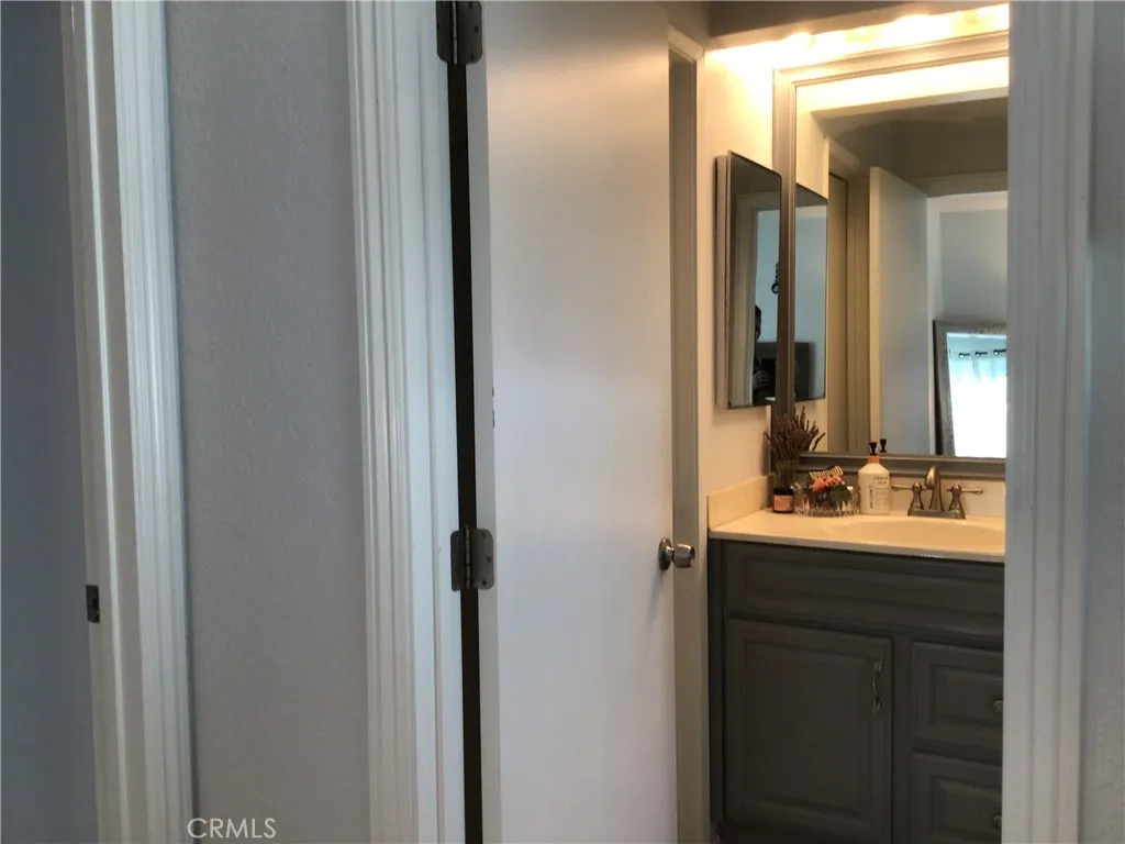 26161 Del Rey, Unit C Mission Viejo, CA 92691 - Photo 6 of 11 a en suite bathroom with a sink and mirror with shower