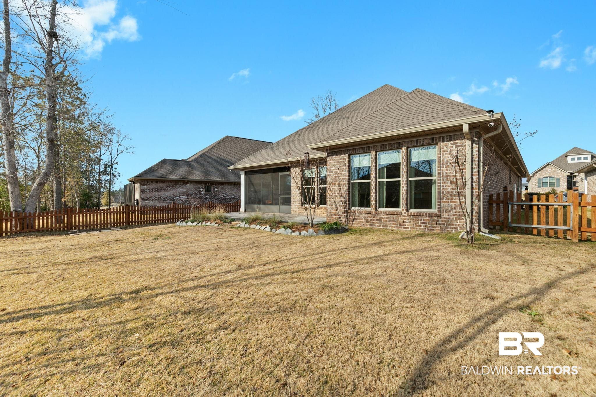 31654 Canopy Loop Daphne, AL 36527 - Photo 54 of 64 Back of house featuring brick siding, a sunroom, a fenced backyard, and roof with shingles
