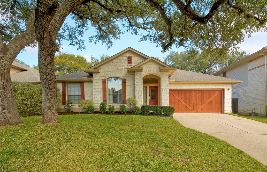 7220 Red Pebble Road Austin, TX 78739 - Photo 1 of 1 a front view of a house with garden