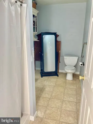 a white toilet sitting in a bathroom