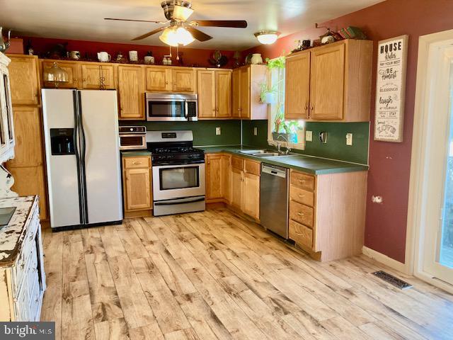 1329 Sheep Hill Road East Earl, PA 17519 - Photo 7 of 15 a kitchen with stainless steel appliances granite countertop a stove top oven a sink and a refrigerator