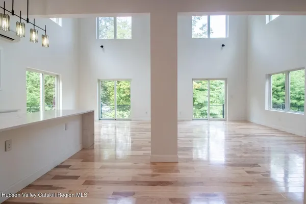 a kitchen with granite countertop a sink window and cabinets