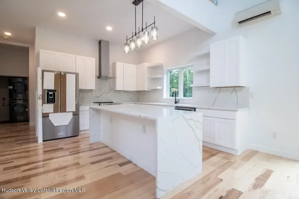 a kitchen with kitchen island a sink stainless steel appliances and cabinets
