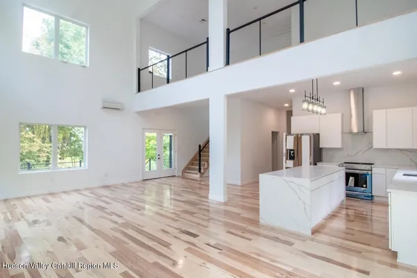 a view of a kitchen with furniture and staircase