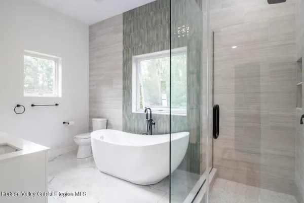 a white bath tub sitting next to a toilet