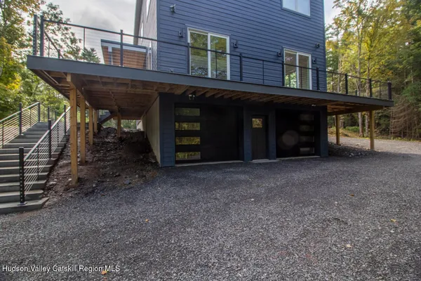 a view of a house with a yard and wooden fence