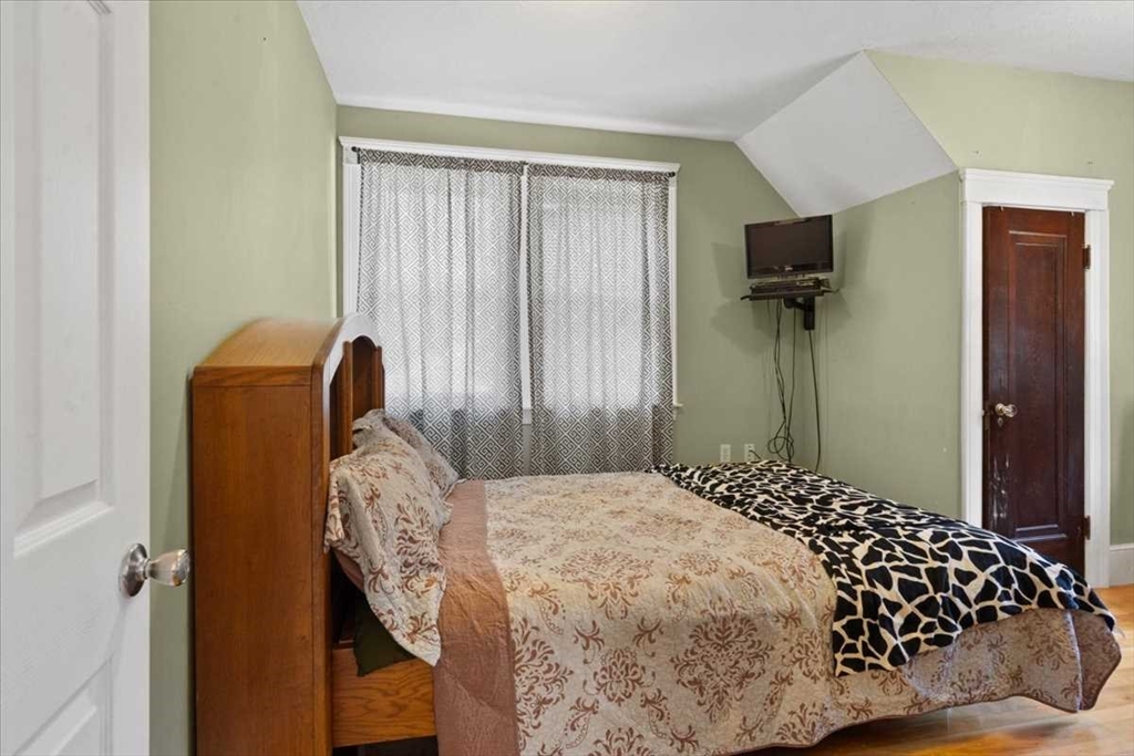18 Joppa Road Worcester, MA 01602 - Photo 18 of 29 a bedroom with a bed and wooden floor