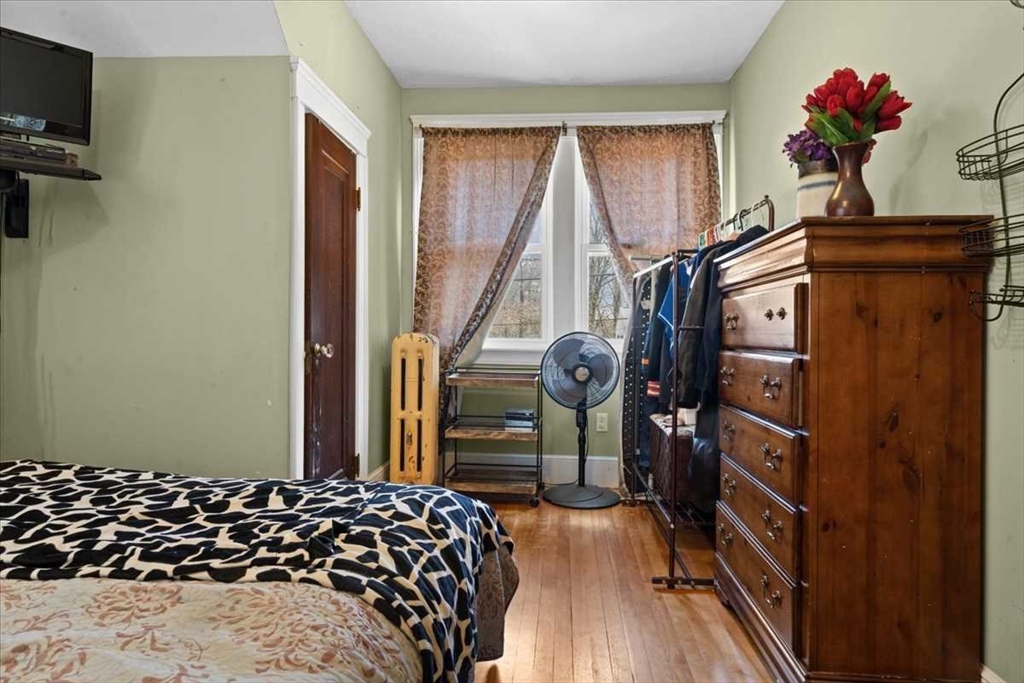 18 Joppa Road Worcester, MA 01602 - Photo 19 of 29 a bedroom with a bed and wooden floor