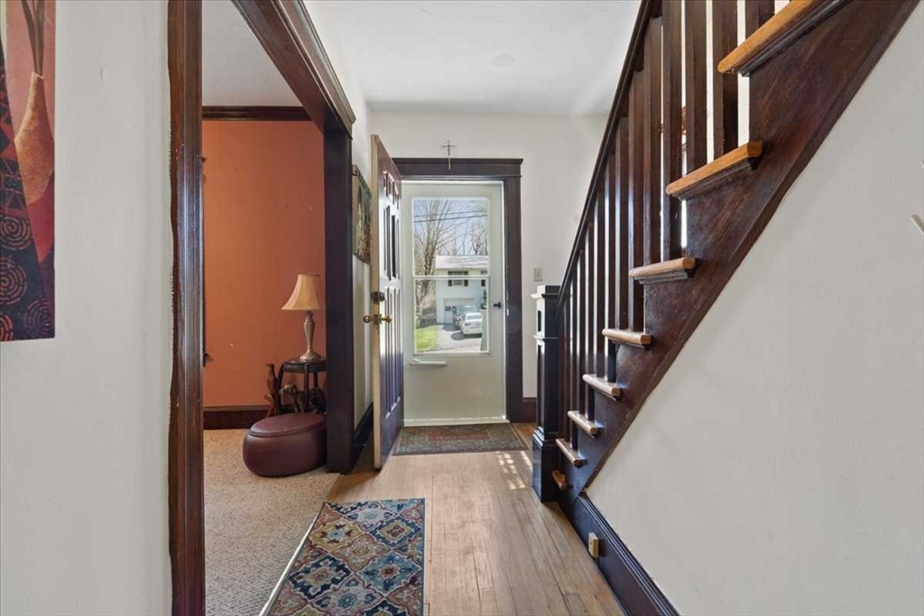 18 Joppa Road Worcester, MA 01602 - Photo 5 of 29 a view of a hallway with wooden floor and stairs