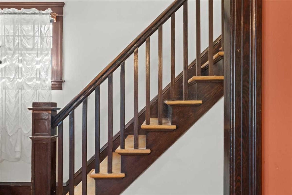 18 Joppa Road Worcester, MA 01602 - Photo 8 of 29 a view of staircase with lots of frames on wall and wooden floor