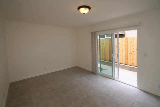 an empty room with a empty space and a window