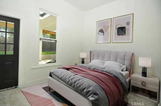 a front view of a house with glass windows and plants