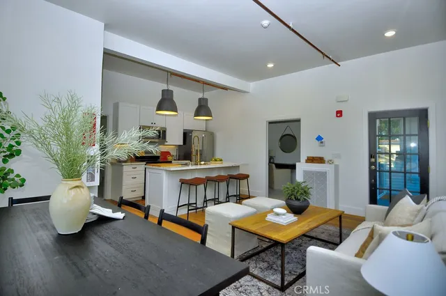 a view of a dining room with furniture wooden floor and a chandelier