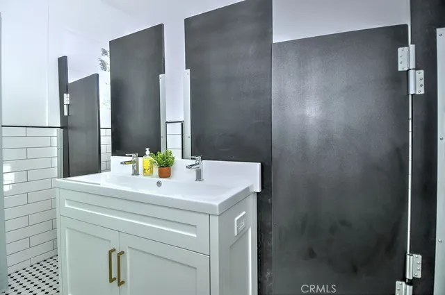 a kitchen that has a sink and a stove in it