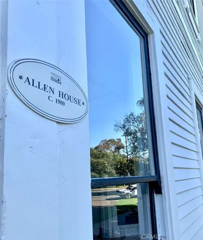a living room with patio furniture and a floor to ceiling window