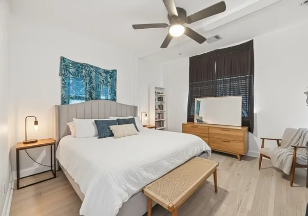 a bedroom with a bed and a chandelier