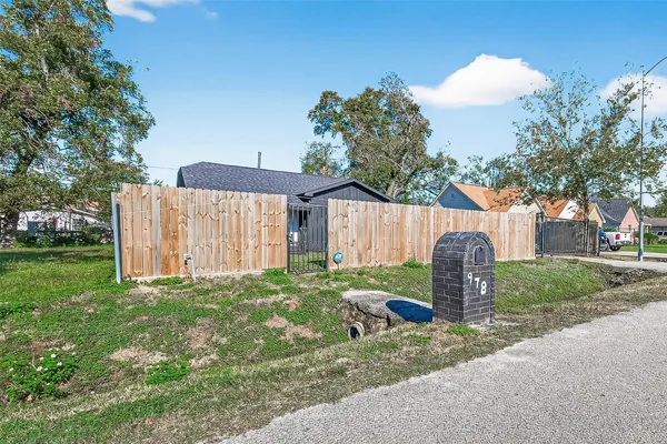a backyard of a house with table and chairs