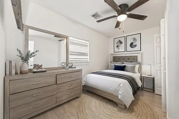 a bedroom with a bed and ceiling fan