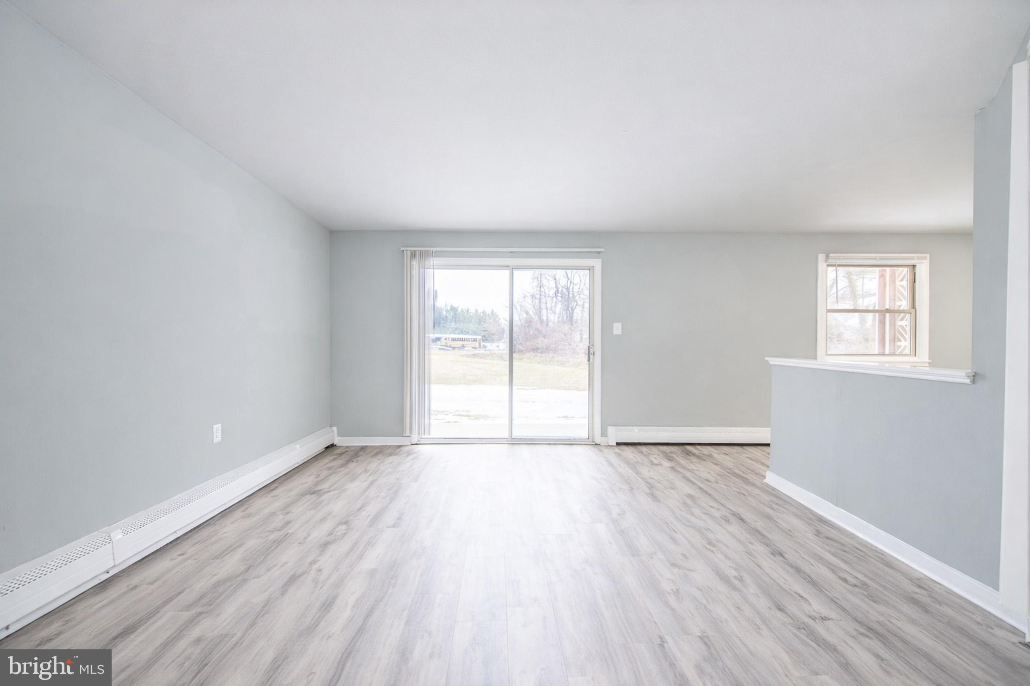 20 Fort Sumpter Road, Unit D10 Pennsville, NJ 08070 - Photo 3 of 9 an empty room with wooden floor and windows