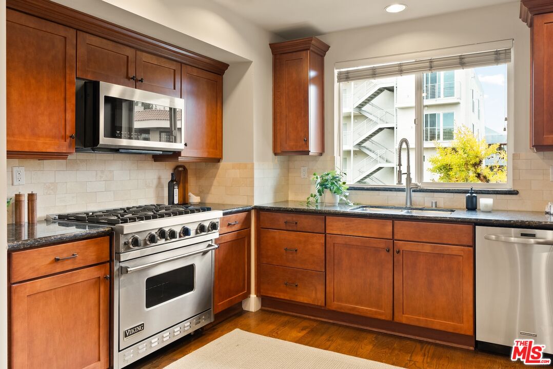3971 Moore Street, Unit 102 Los Angeles, CA 90066 - Photo 14 of 35 a kitchen with stainless steel appliances a stove a sink and a microwave
