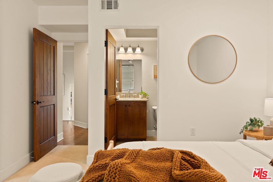 3971 Moore Street, Unit 102 Los Angeles, CA 90066 - Photo 17 of 35 a bedroom with a bed and a mirror