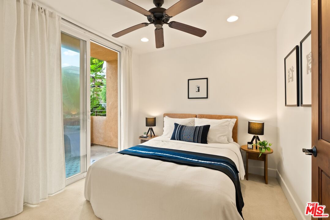 3971 Moore Street, Unit 102 Los Angeles, CA 90066 - Photo 22 of 35 a bedroom with a large bed and a chandelier