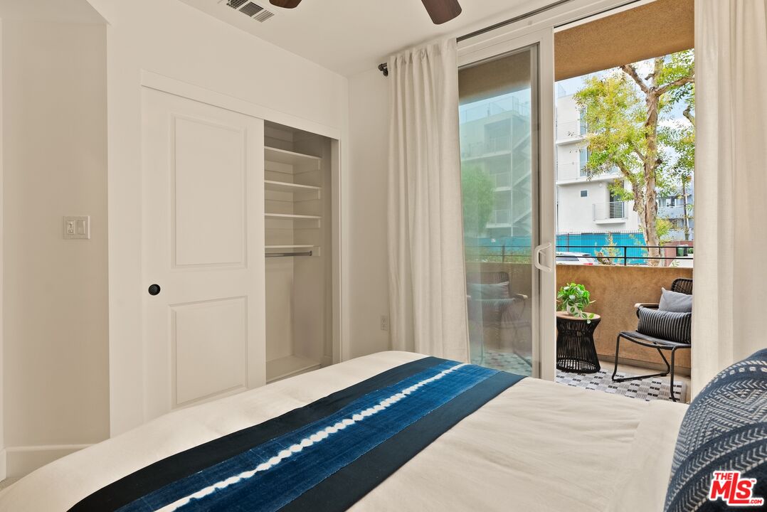 3971 Moore Street, Unit 102 Los Angeles, CA 90066 - Photo 23 of 35 a bedroom with a bed and wooden floor