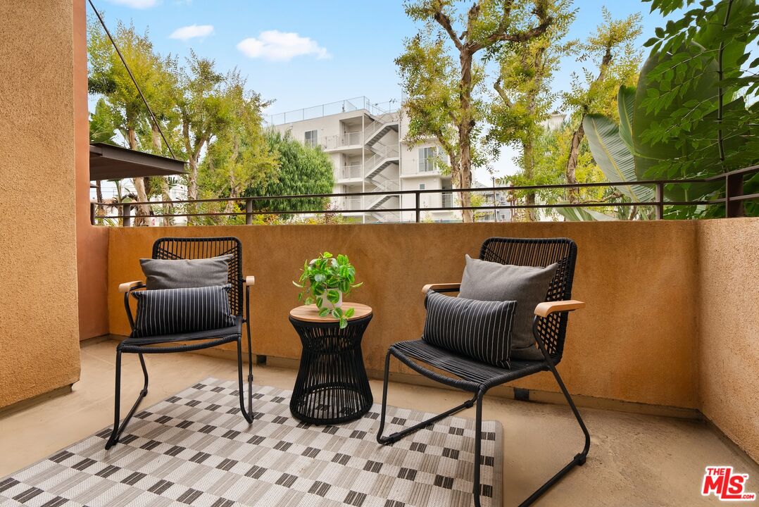 3971 Moore Street, Unit 102 Los Angeles, CA 90066 - Photo 25 of 35 a balcony with couple of chairs and a potted plant