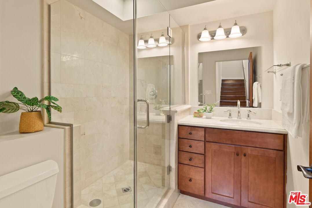 3971 Moore Street, Unit 102 Los Angeles, CA 90066 - Photo 26 of 35 a bathroom with a double vanity sink and mirror